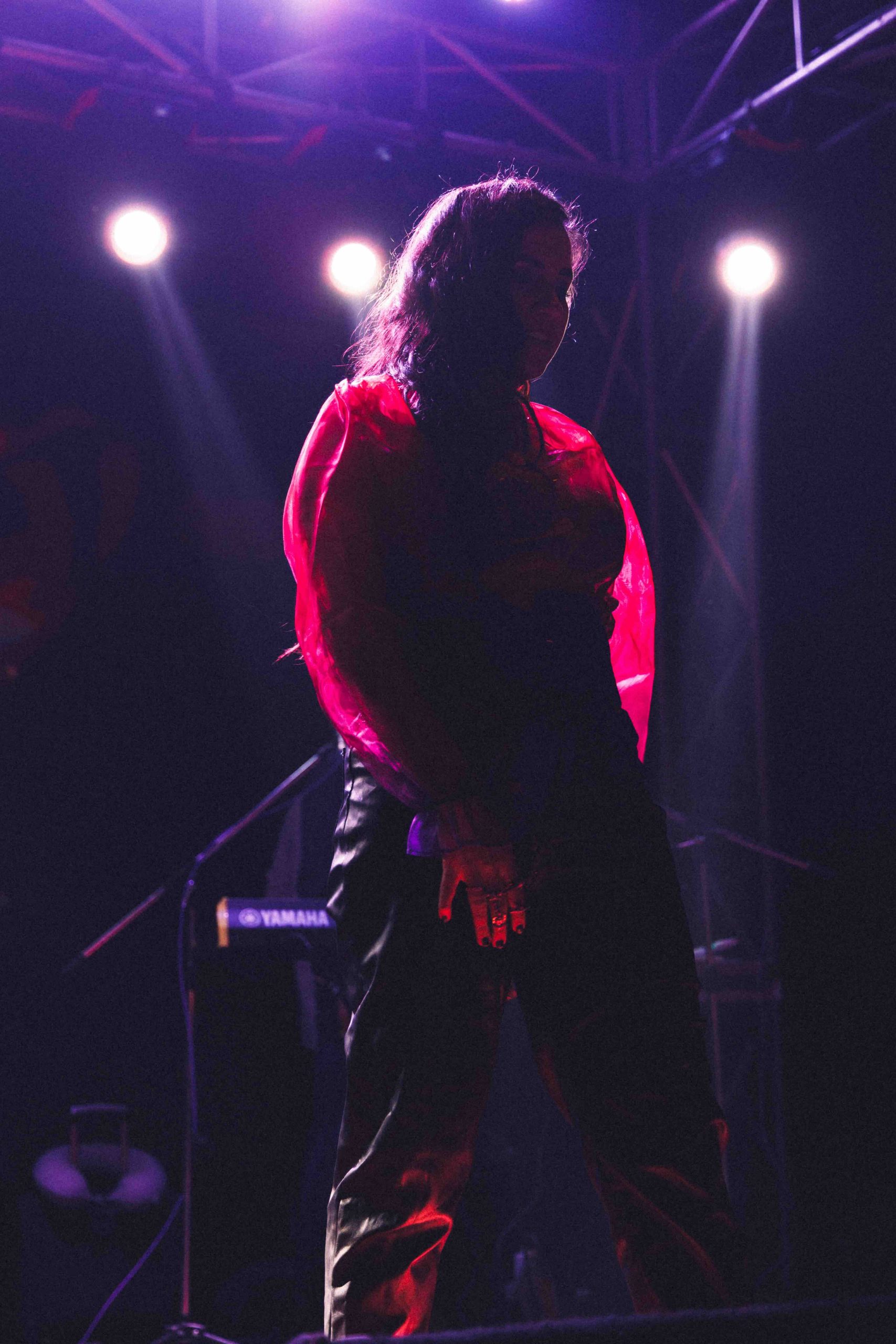 Performer silhouetted in red stage light
