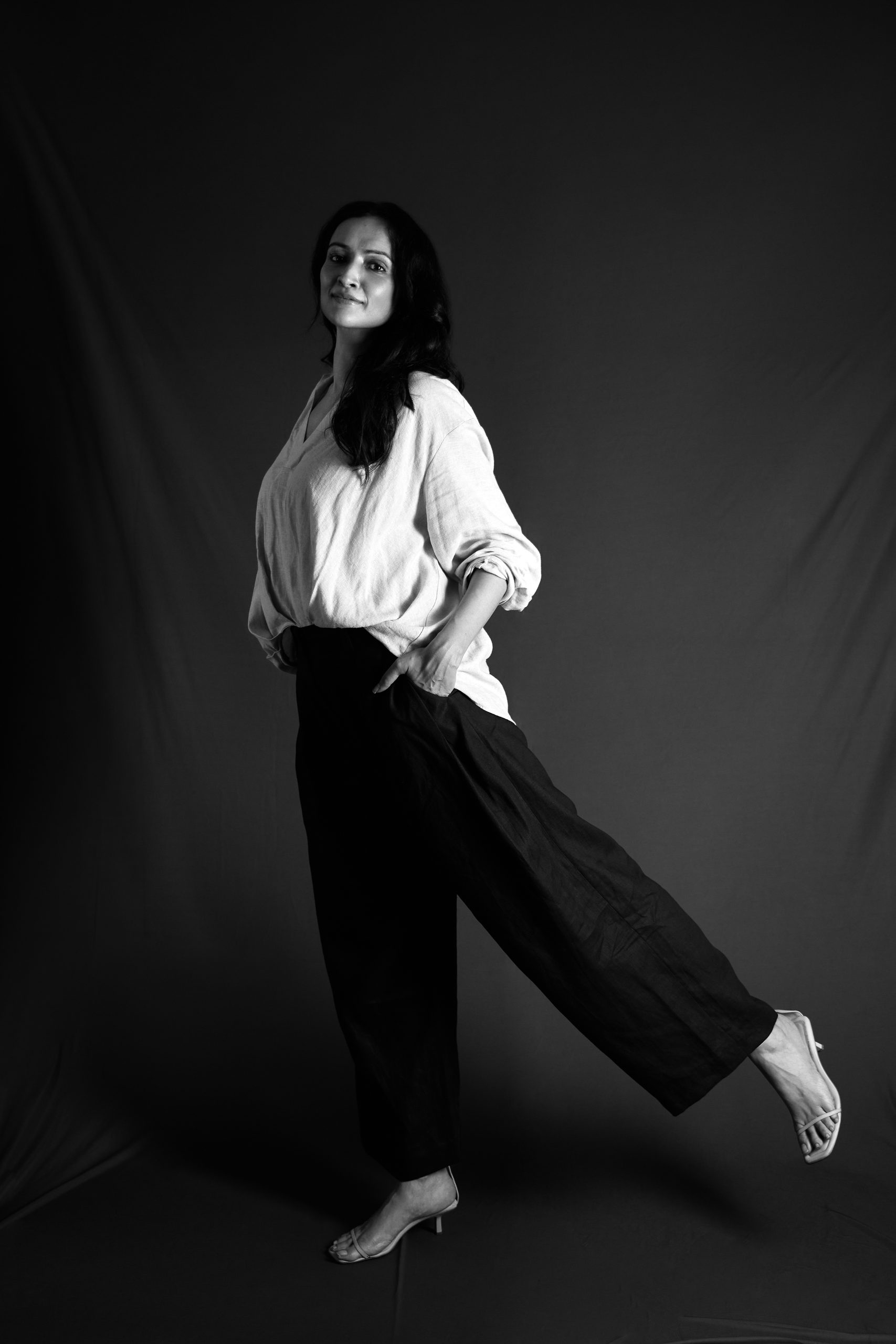 Black-and-white studio portrait, full length